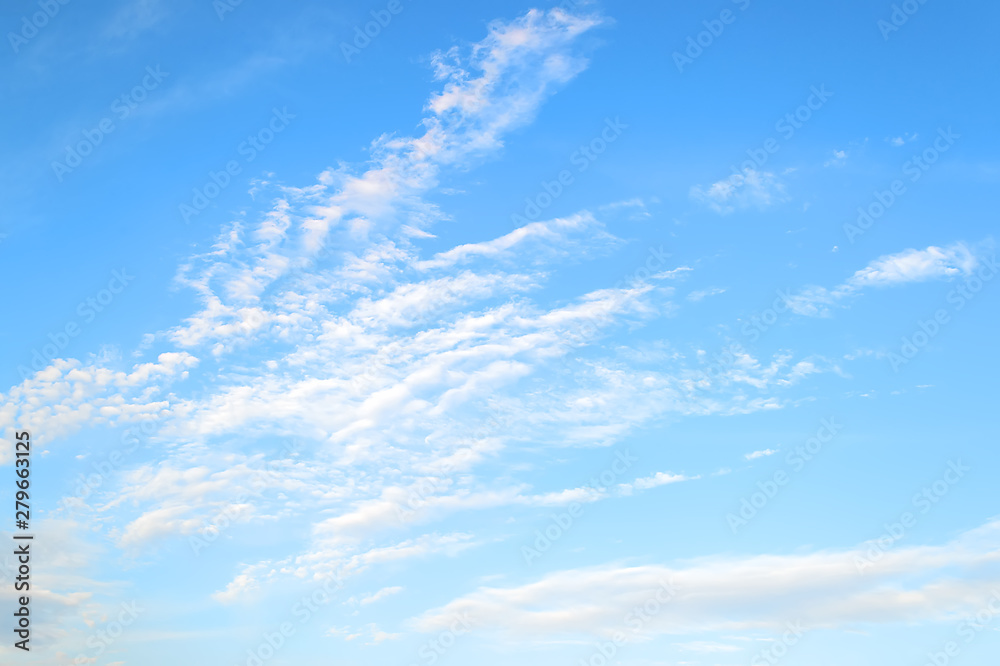 Obraz premium White translucent stratus and cirrus clouds high in the blue summer sky. Different cloud types and atmospheric phenomena.