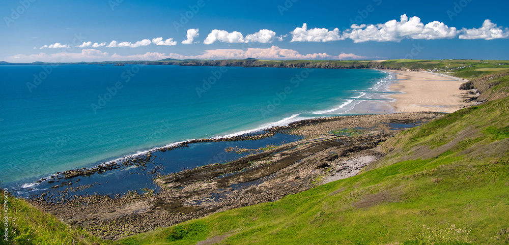 Newgale Beach in Pembrokeshire, Wales, UK on a summer day with blue sky and clouds