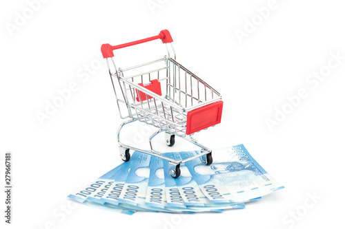 Stacks of chilean notes under shopping cart or supermarket trolley, business finance shopping concept. Chile money.