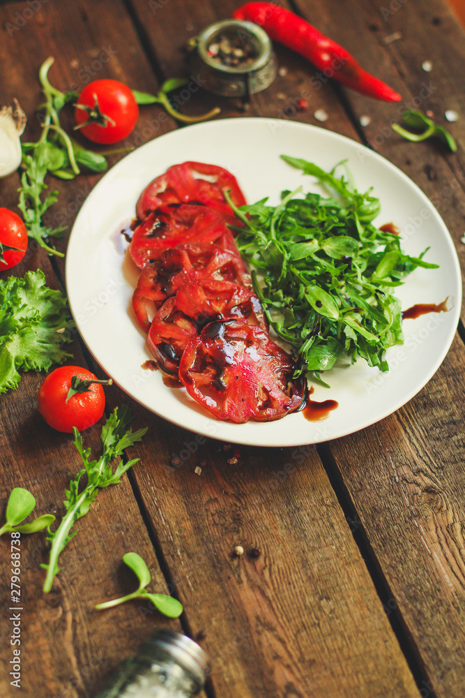 tomatoes salad with sunflower seedlings microgreen (carpaccio, sliced raw vegetables). food background. top view. copy space tomatoes salad with sunflower seedlings microgreen (carpaccio, sliced raw vegetables). food background. top view. copy space