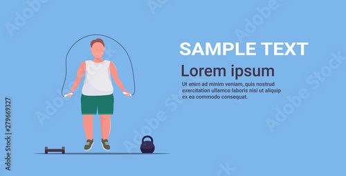 fat obese man doing exercises with jumping rope overweight guy training workout weight loss concept flat full length blue background horizontal copy space