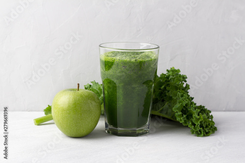 Green smoothie with kale cabbage and apple on a gray background. delicious healthy vegan food	