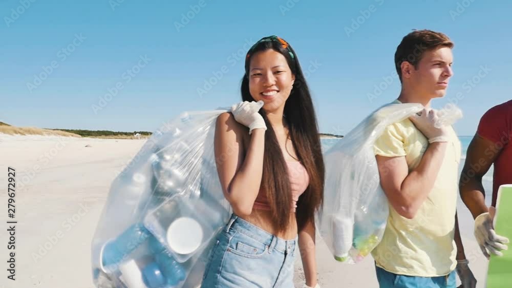 Group of friends collecting plastic waste on the beach. activists at work to clean up for a better world. concept about pollution and environment conservation Group of friends collecting plastic waste on the beach. activists at work to clean up for a better world. concept about pollution and environment conservation