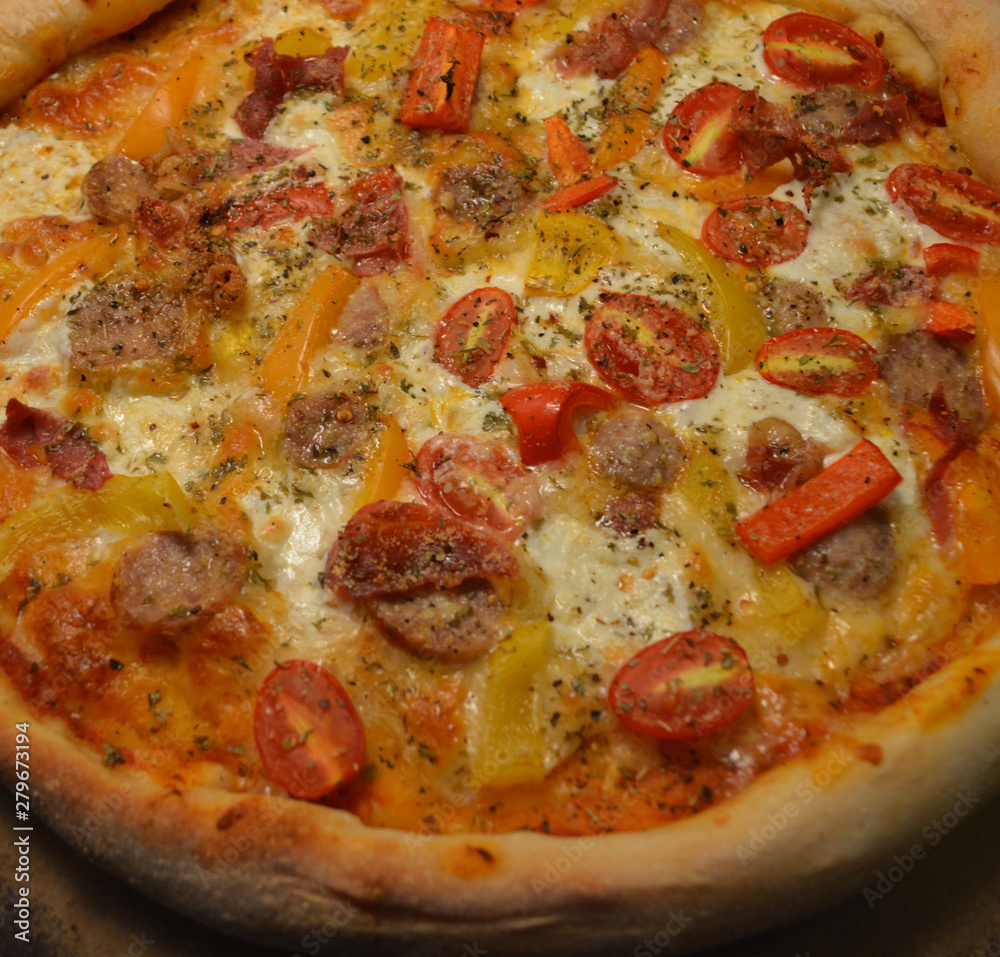 Fresh Home Made Italian Style Pizza Topped with Tomato, Sausage, Mozzarella, and Vegetables Fresh Home Made Italian Style Pizza Topped with Tomato, Sausage, Mozzarella, and Vegetables
