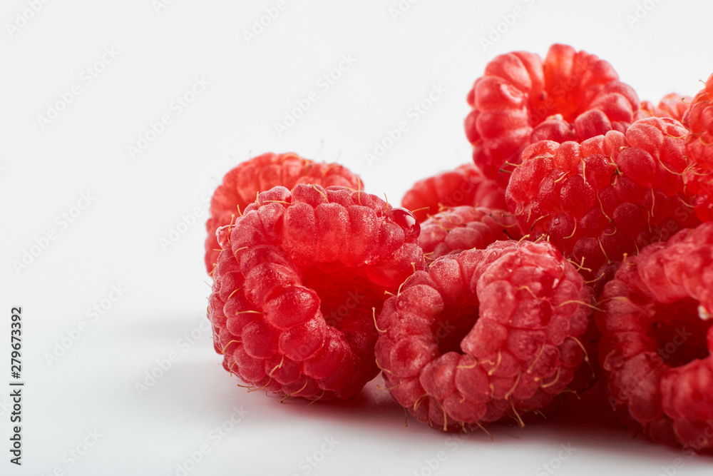 ripe raspberries with green leaf isolated on white background macro ripe raspberries with green leaf isolated on white background macro