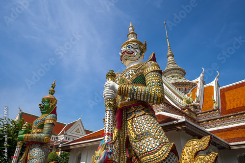 Bangkok, Thailand at Wat Arun Temple, Giant Statue guarding the entrance to the temple, Bangkok, Thailand. on the Thonburi west bank of the Chao Phraya River.