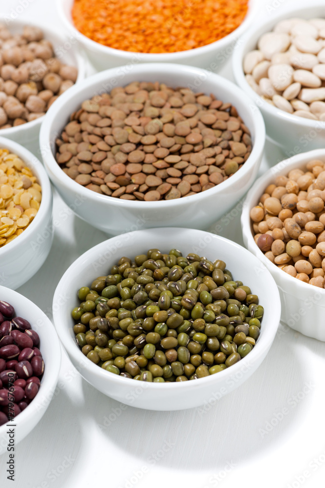assortment of various legumes in bowls, vertical assortment of various legumes in bowls, vertical