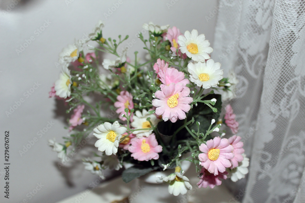 Pink and white flowers bouqet in a dorm