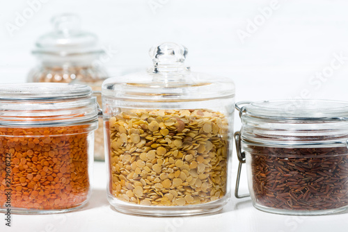 assortment of various cereals and legumes in glass jars