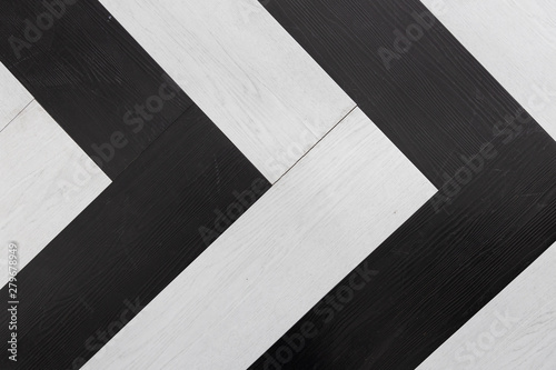 top view of black and white wooden herringbone floor background texture  Looks like direction arrow symbol.
