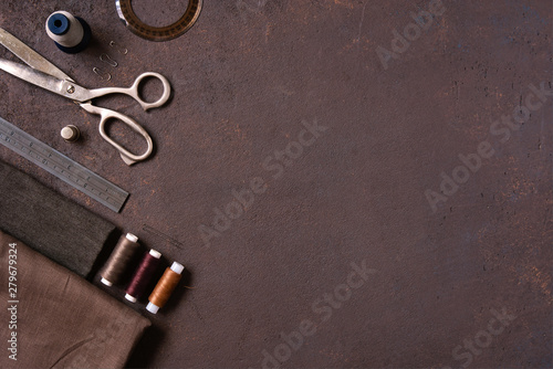 Brown textured background with sewing tools