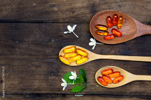 Omega 3 fish oil capsules  for good brain , heart and health. place on old  wooden plat.