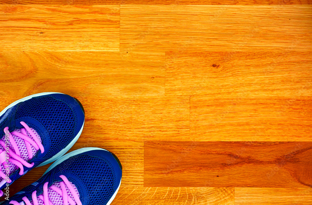 Blue and pink running shoes on wooden floor. Blue and pink running shoes on wooden floor.