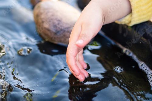 Child hand and water