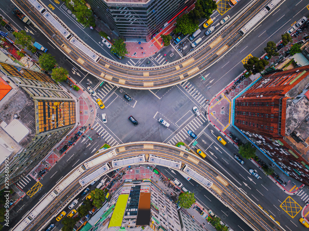 Obraz premium Aerial view of cars and trains with intersection or junction with traffic, Taipei Downtown, Taiwan. Financial district and business area. Smart urban city technology.