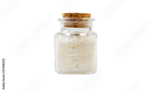 coconut shreds in glass  jar on isolated on white background. front view. spices and food ingredients.