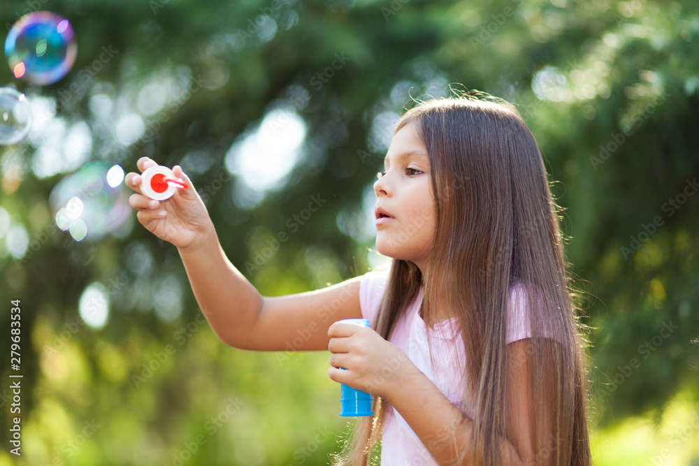 Children girl blowing soap bubbles outdoor Children girl blowing soap bubbles outdoor