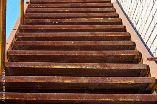 Background of old staircase on a building, rusty metal stairs