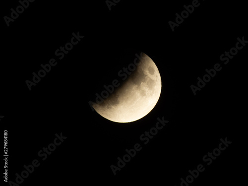 Progressing partial lunar eclipse with visible lunar seas and craters on moon surface