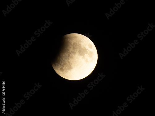 Progressing partial lunar eclipse with visible lunar seas and craters on moon surface