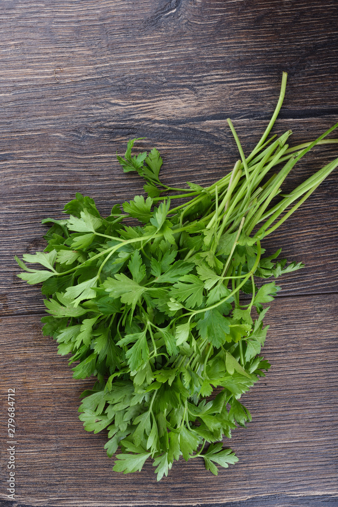 Fresh parsley on wooden table. Top view. Fresh parsley on wooden table. Top view.
