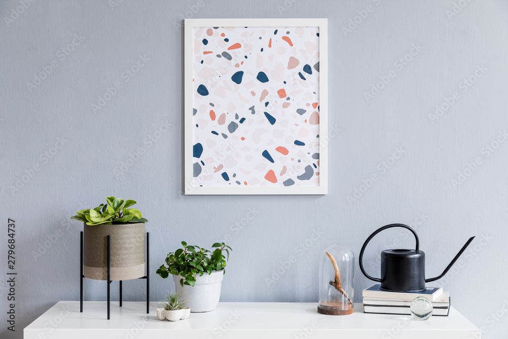 Modern scandinavian interior of living room at nice apartment with mock up poster frame, white shelf, plants, watering can, books, air plant and elegant accessories. Stylish home decor. Template.