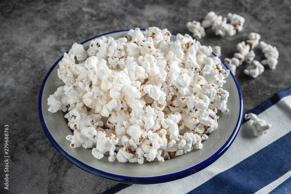 popcorn in a plate on the table, gray background, copy space, close-up popcorn in a plate on the table, gray background, copy space, close-up