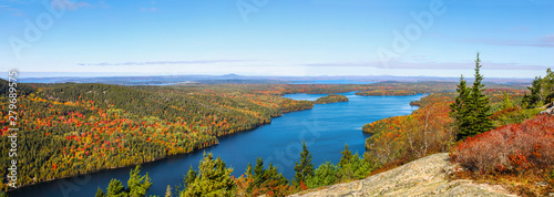 Panoramic aerial view of the blue water and fall foliage surrounding Long Pond in Acadia National Park