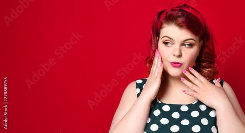 Pin up girl vintage. Beautiful woman pinup style portrait in retro dress and polka dot dress. Studio shot.