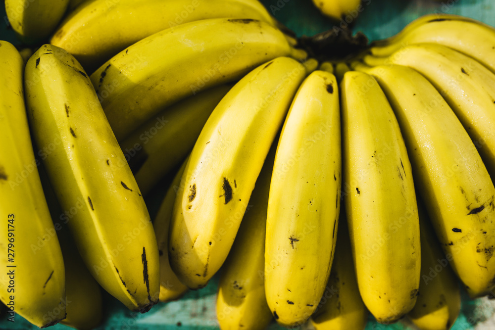 Closeup of a bunch of ripe mini bananas - fruit market - selective focus