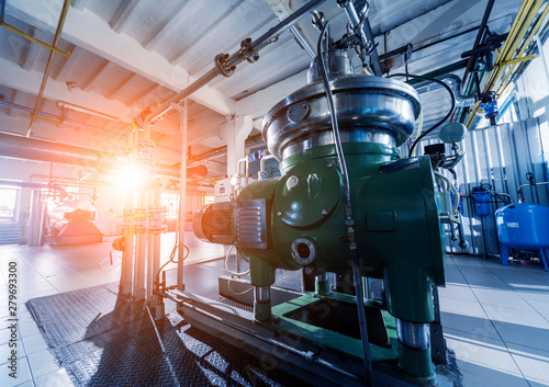 Interior of modern natural oil factory. The piping, pumps and motors