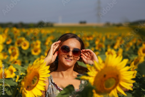 Cute girl in the field full of sunflowers © leomalsam