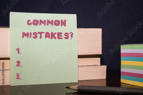 Conceptual hand writing showing Common Mistakes question. Concept meaning repeat act or judgement misguided or wrong Close up three wooden rectangle boxes paper pencil stack