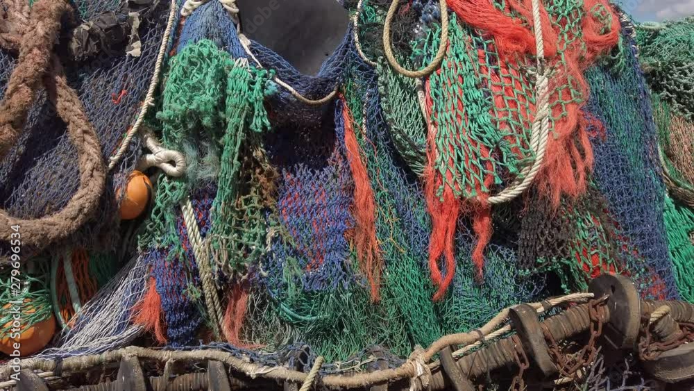 Tilt up over the colourful fishermans nets in Dorset England