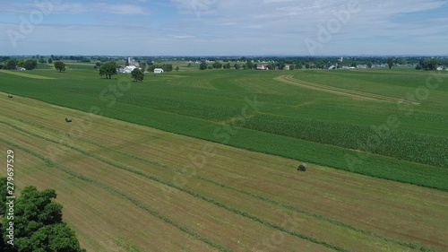 Amish Farmer Harvesting His Crop with 4 Horses and Modern Equipment