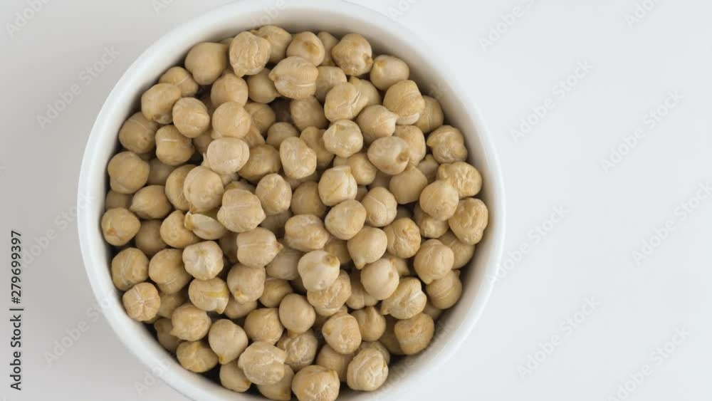 Rotating raw chickpea beans on a white background. Rotating raw chickpea beans on a white background.