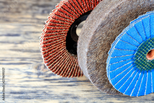 Set for grinding of petal circles from different grains and a felt circle on a light beige background in unsharpness. photo