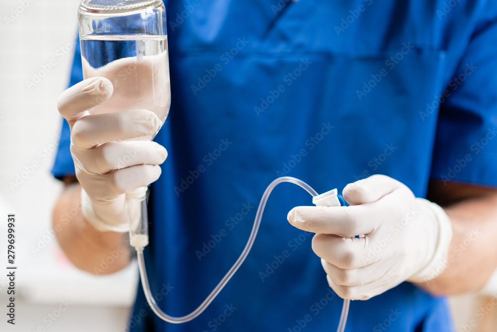 custom made wallpaper toronto digitalDoctor in blue uniform holding drip iv and infusion pump, . Intravenous fluid for seriously patient in the emergency room at hospital. Medical treatment emergency concept.