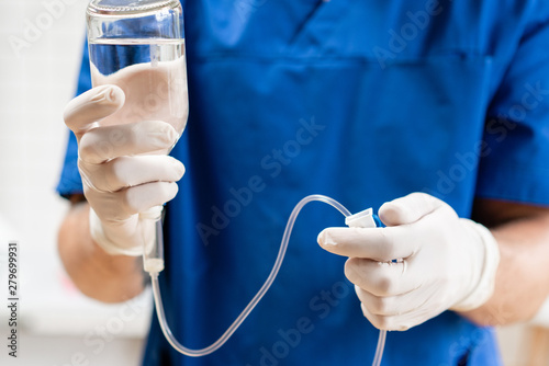 Wallpaper Mural Doctor in blue uniform holding drip iv and infusion pump, . Intravenous fluid for seriously patient in the emergency room at hospital. Medical treatment emergency concept. Torontodigital.ca