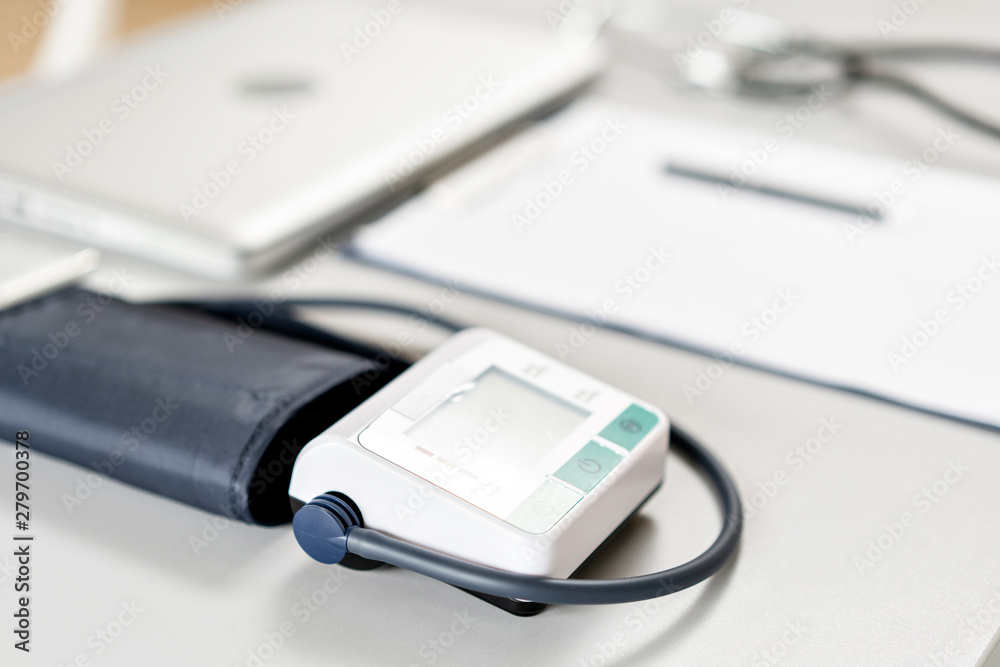 Stethoscope, measuring blood pressure and laptop on wooden desk for analysis of medical results. Stethoscope, measuring blood pressure and laptop on wooden desk for analysis of medical results.