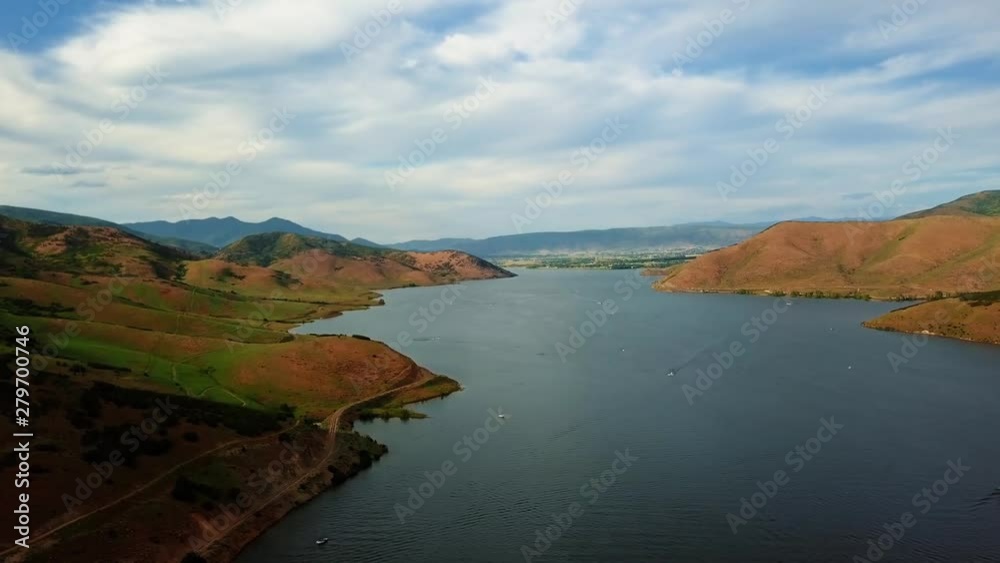 Beautiful landscape view of Deer Creek Reservoir in Heber Valley Utah with speed boats and jet skis on the lake on a cloudy summer day. Beautiful landscape view of Deer Creek Reservoir in Heber Valley Utah with speed boats and jet skis on the lake on a cloudy summer day.