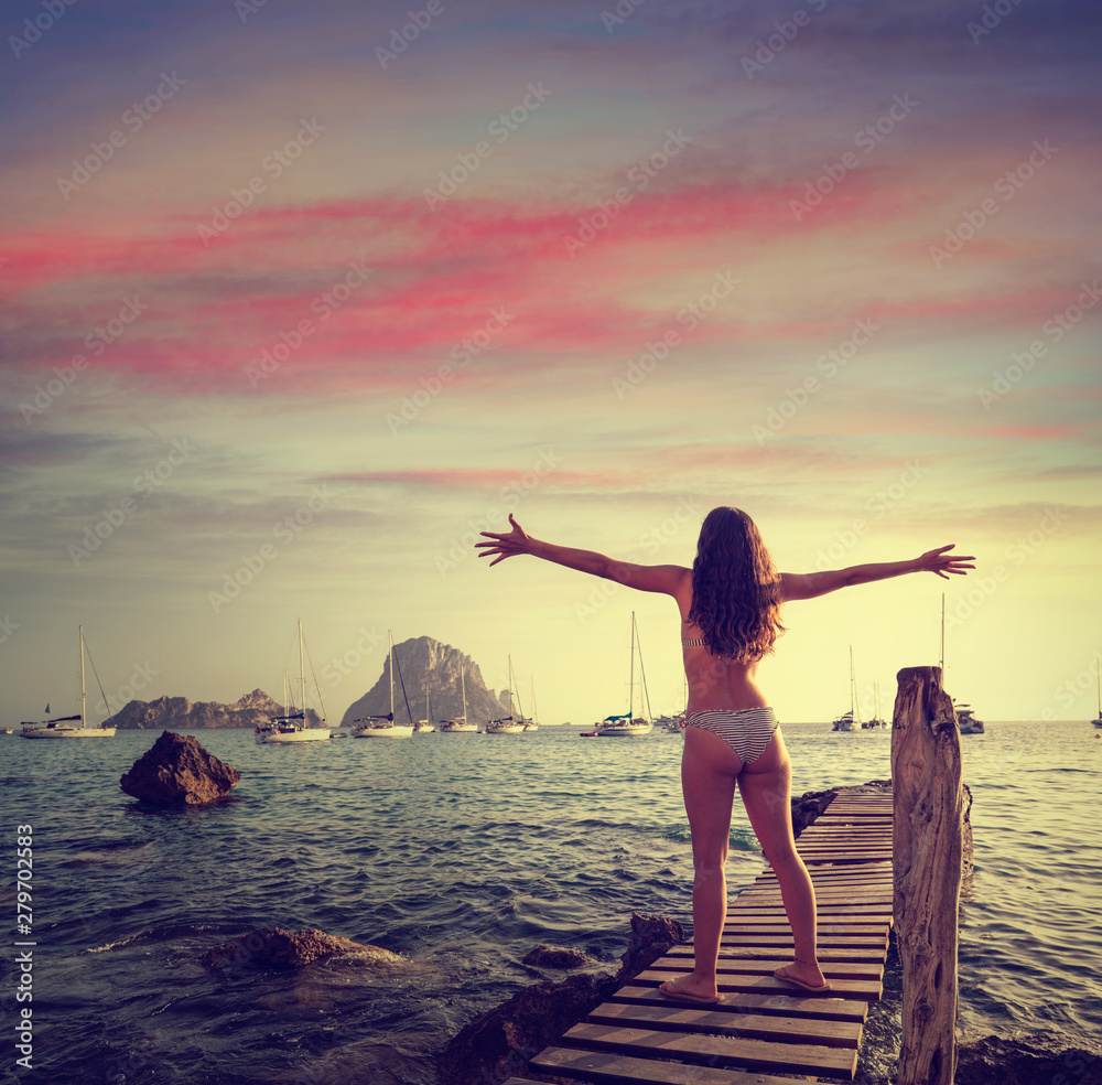 Fototapeta premium Ibiza cala d Hort girl pier sunset Es Vedra