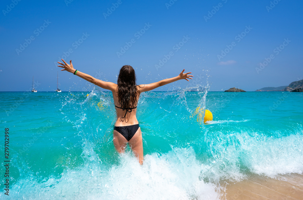 Ibiza beach girl splashing water in Balearics Ibiza beach girl splashing water in Balearics