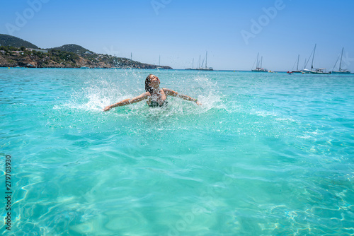 Ibiza bikini girl splashing clear water beach © lunamarina