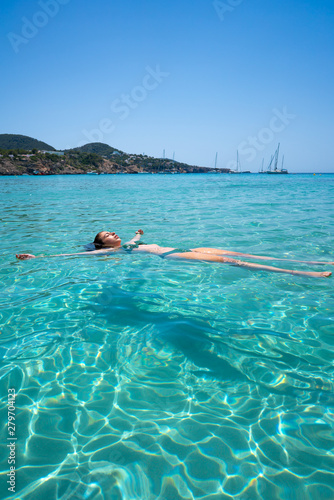Ibiza bikini girl swimming clear water beach © lunamarina