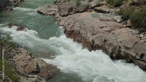 Mountain river goes through the granite canyon