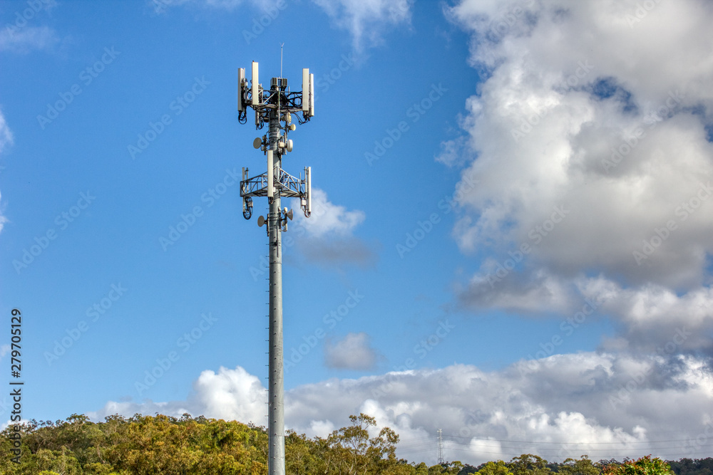 Cellular, mobile phone transmitter tower with blue sky and clouds2