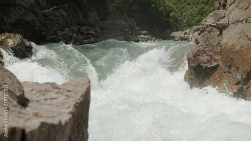 Mountain river goes through the granite canyon