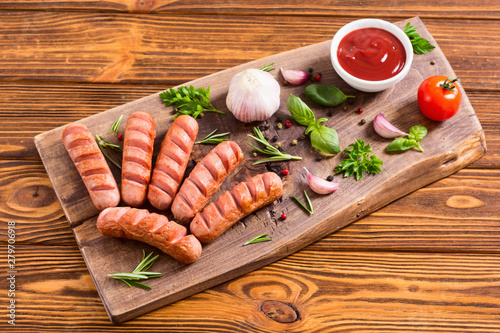 Fried sausages with herbs , spices and ketchup