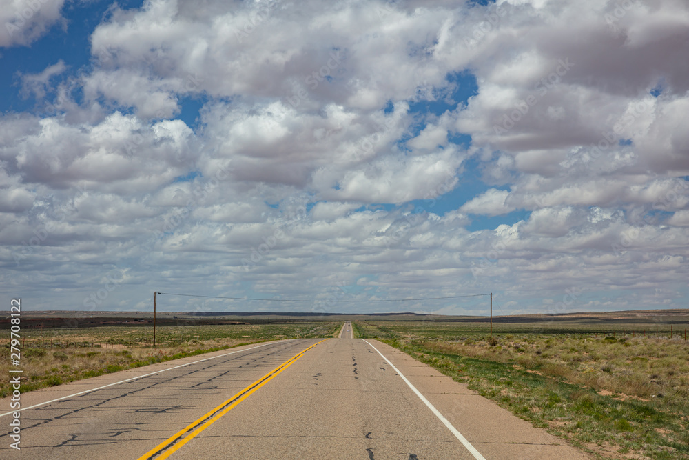 Long highway in the american desert, cloudy blue sky Long highway in the american desert, cloudy blue sky